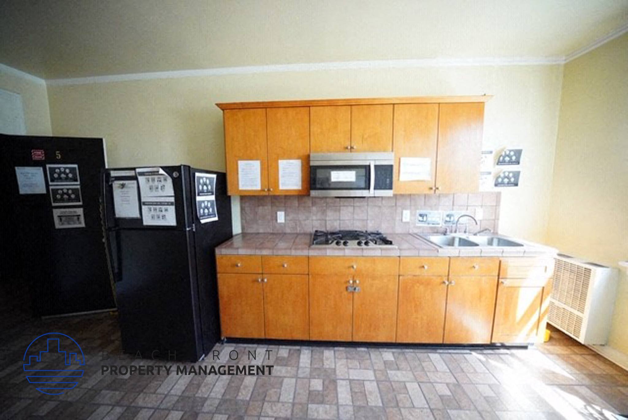 an empty kitchen with wooden cabinets and a sink
